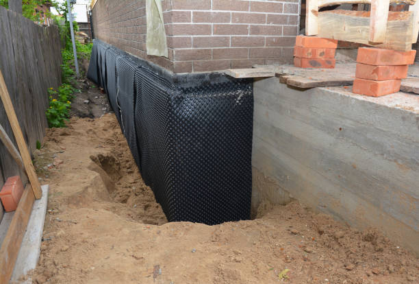 Happy homeowners after waterproofing job in Trafford